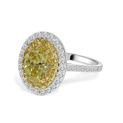 Ring with a yellow diamond and white diamond halo on a white background. Diamond Engagement ring