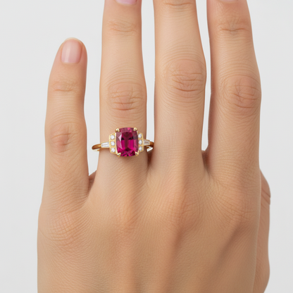 Gold ring with a rubelite tourmaline and diamond accents on a white background