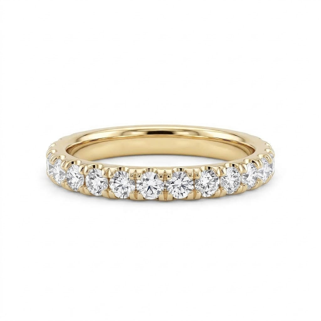 An 18K yellow gold wedding ring featuring a row of  claw set round brilliant-cut diamonds 