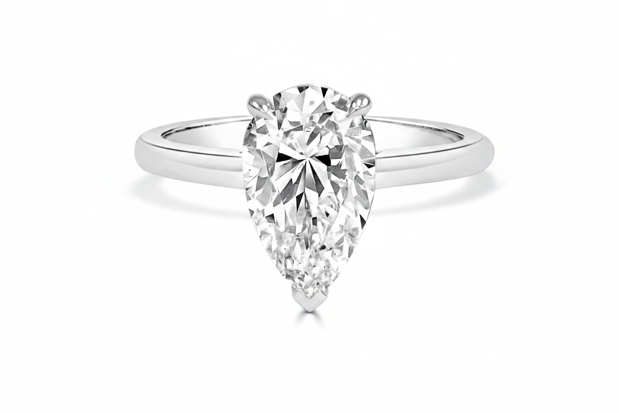 White Gold ring with a pear-shaped diamond on a white background