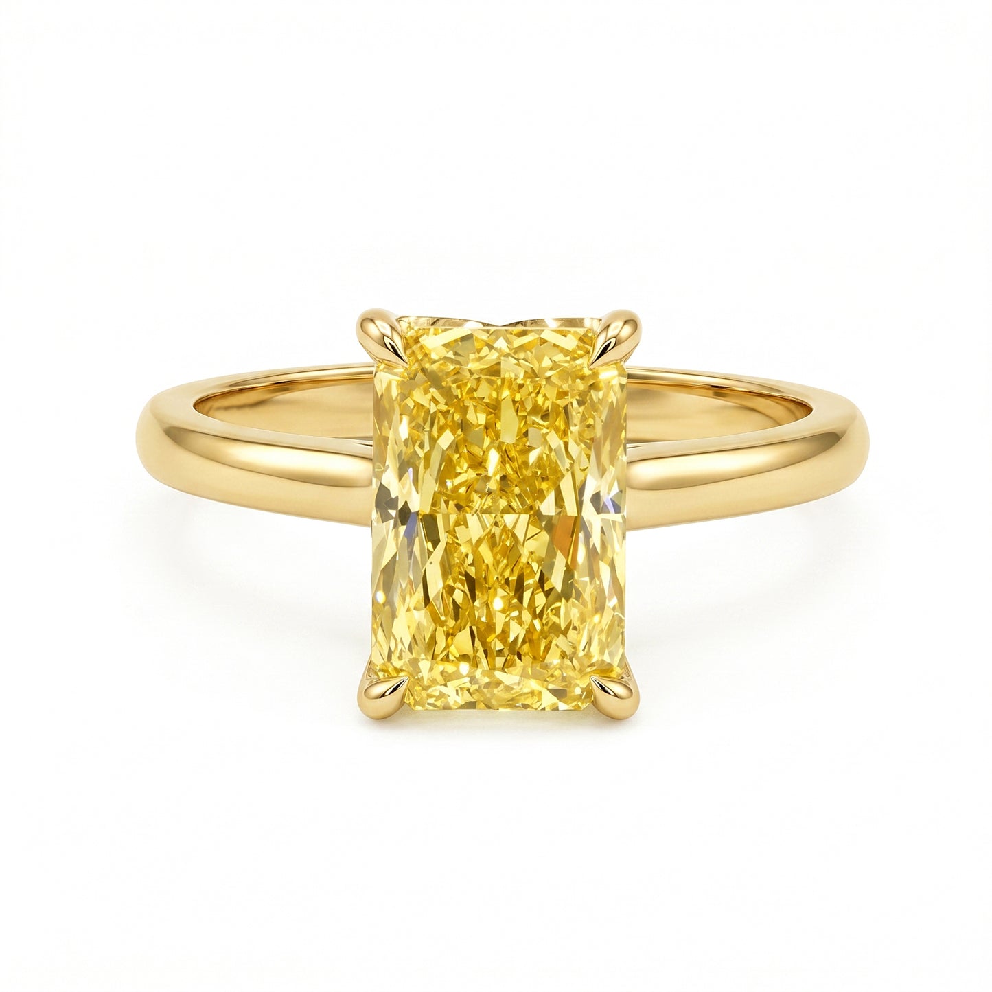 A yellow diamond engagement ring with a rectangular radiant-cut center stone in a four-prong setting on a polished yellow gold band, shown against a plain white background.