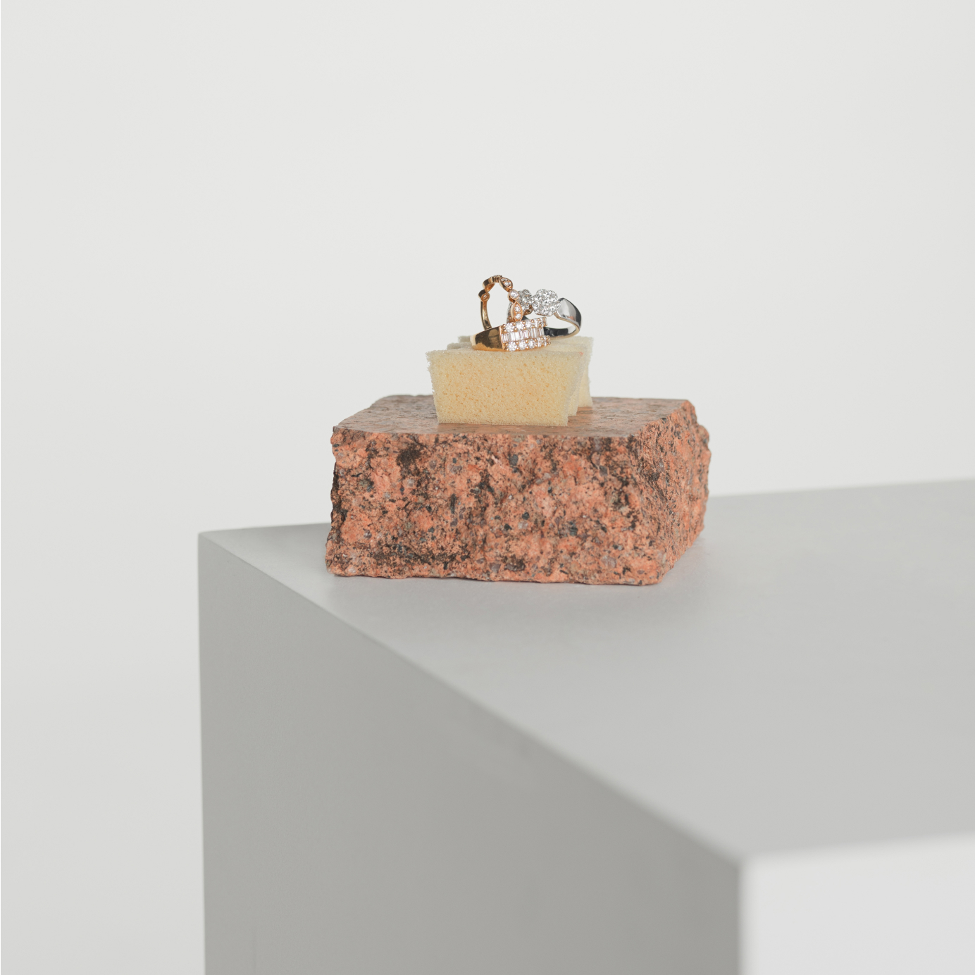 Three Diamond dress rings sit upon a terracotta stone