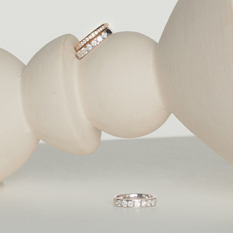 Three diamond rings sitting on a white pillar